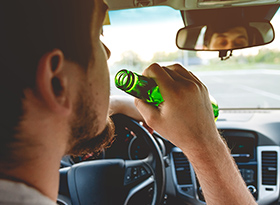 Man drinking in vehicle