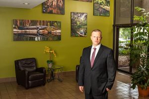 Jonathan Torres standing in lobby with pictures on wall