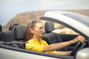 young female driver in convertible